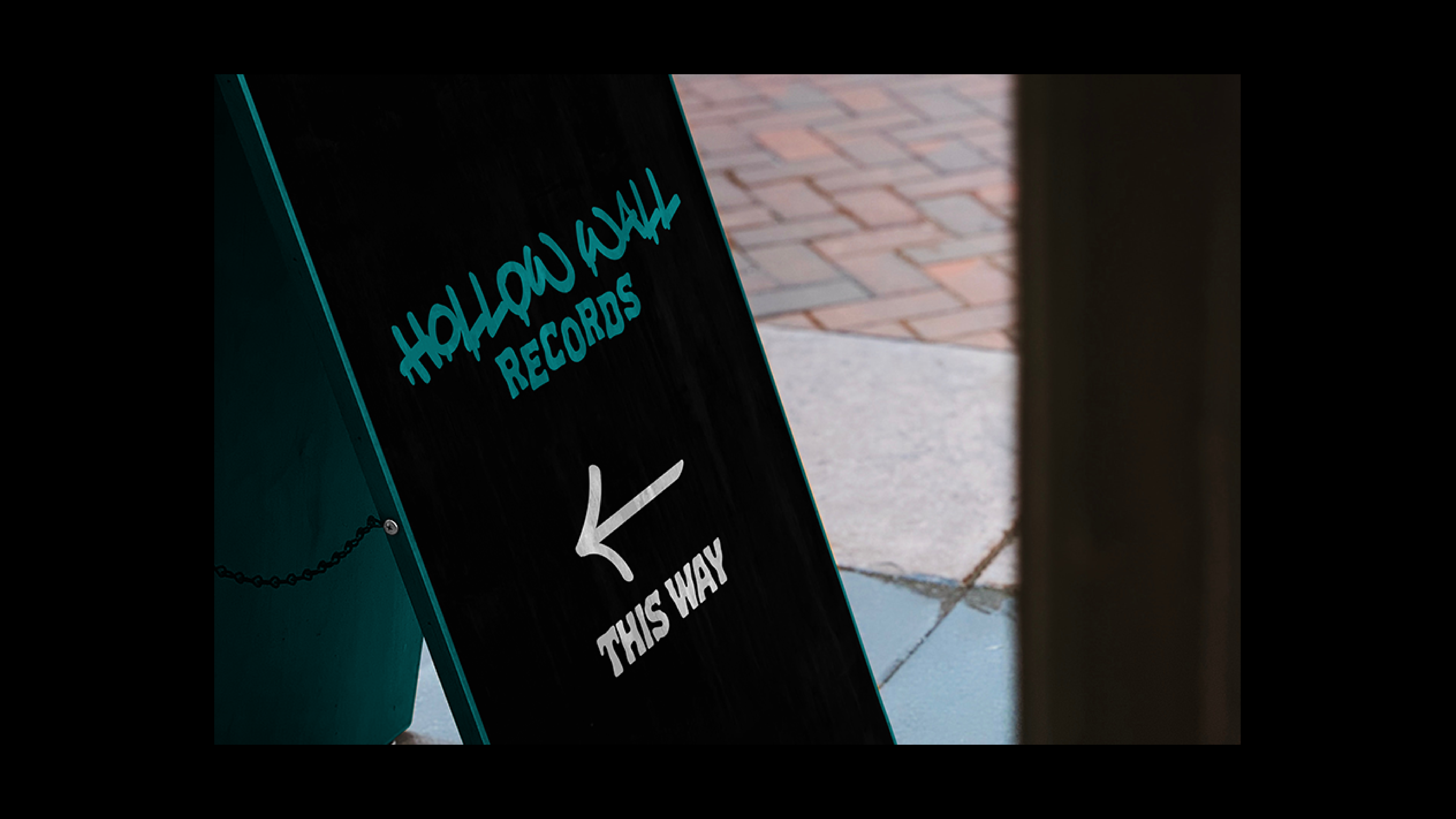 Hollow Wall Records Logo on a Sign